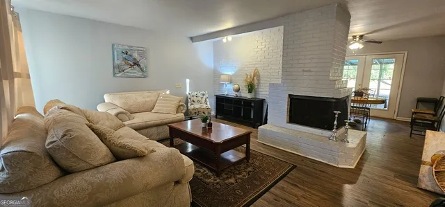a kitchen with a refrigerator a table and chairs in it