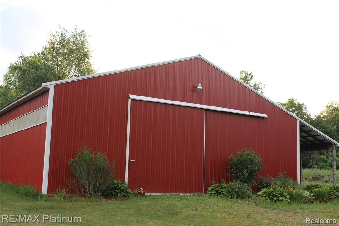 6691 Mabley Hill Road Fenton, MI 48430 - Photo 2 of 28 42X64 pole barn concrete floor, light panel on side with 10x32 lean to