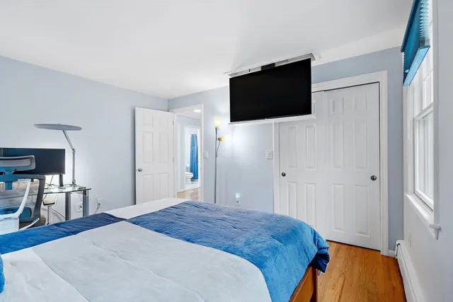 a bedroom with a bed and a flat screen tv