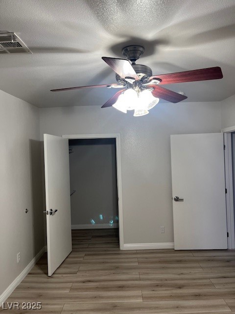 1602 Foothill Drive Boulder City, NV 89005 - Photo 15 of 25 Unfurnished bedroom with light wood-type flooring, a textured ceiling, and ceiling fan