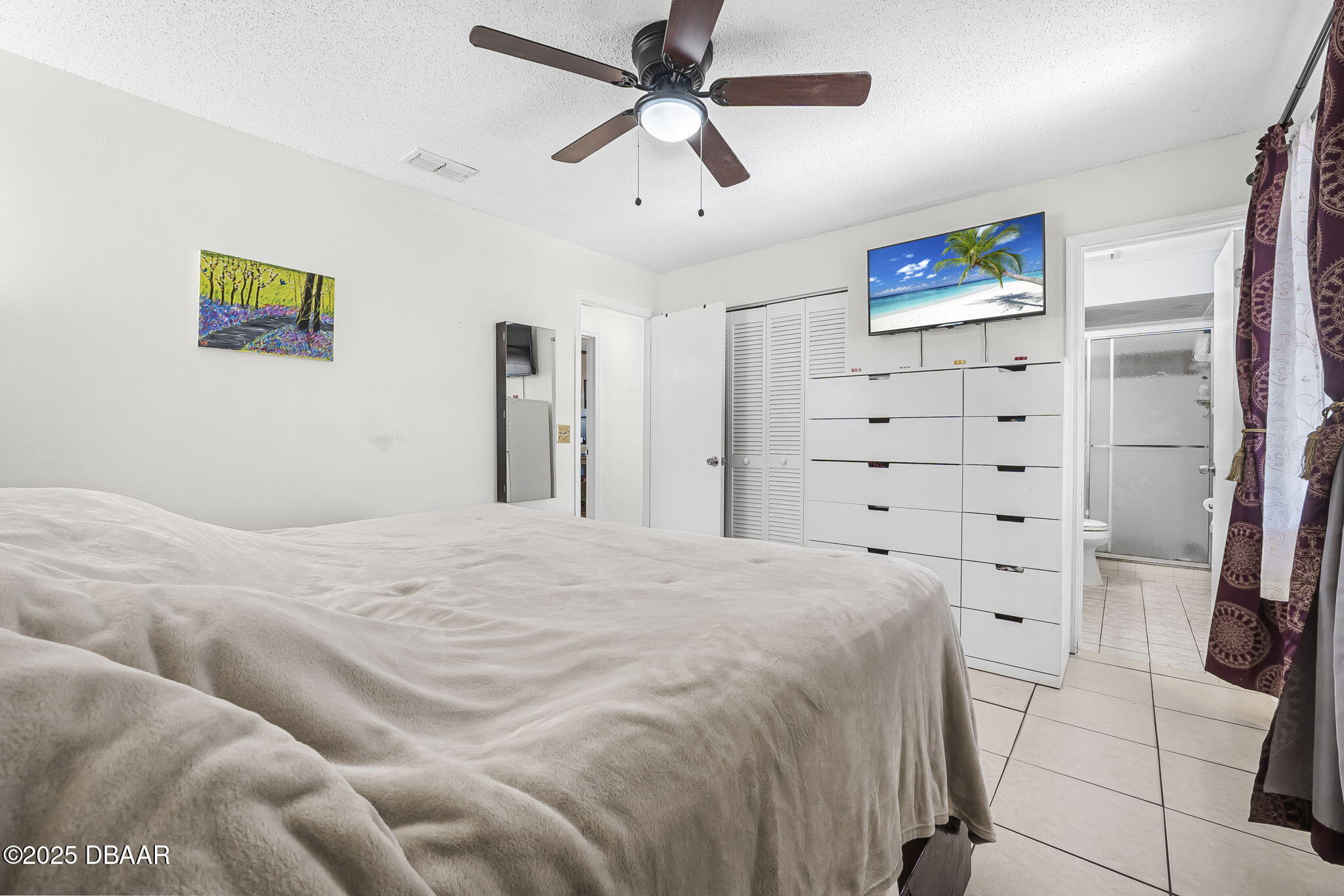3228 Unity Tree Drive Edgewater, FL 32141 - Photo 14 of 37 a bedroom with a bed and a walk in closet