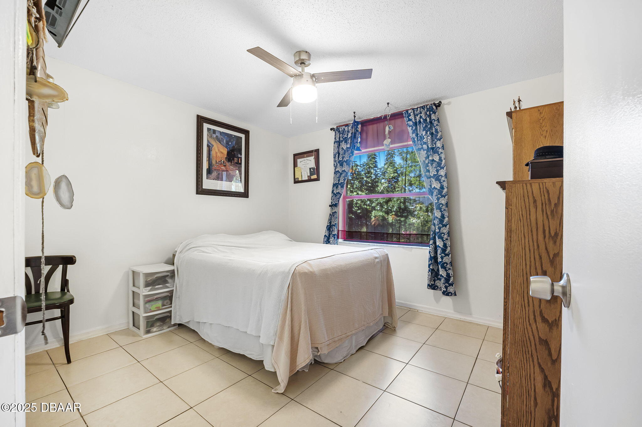 3228 Unity Tree Drive Edgewater, FL 32141 - Photo 17 of 37 a spacious bedroom with a bed and a window