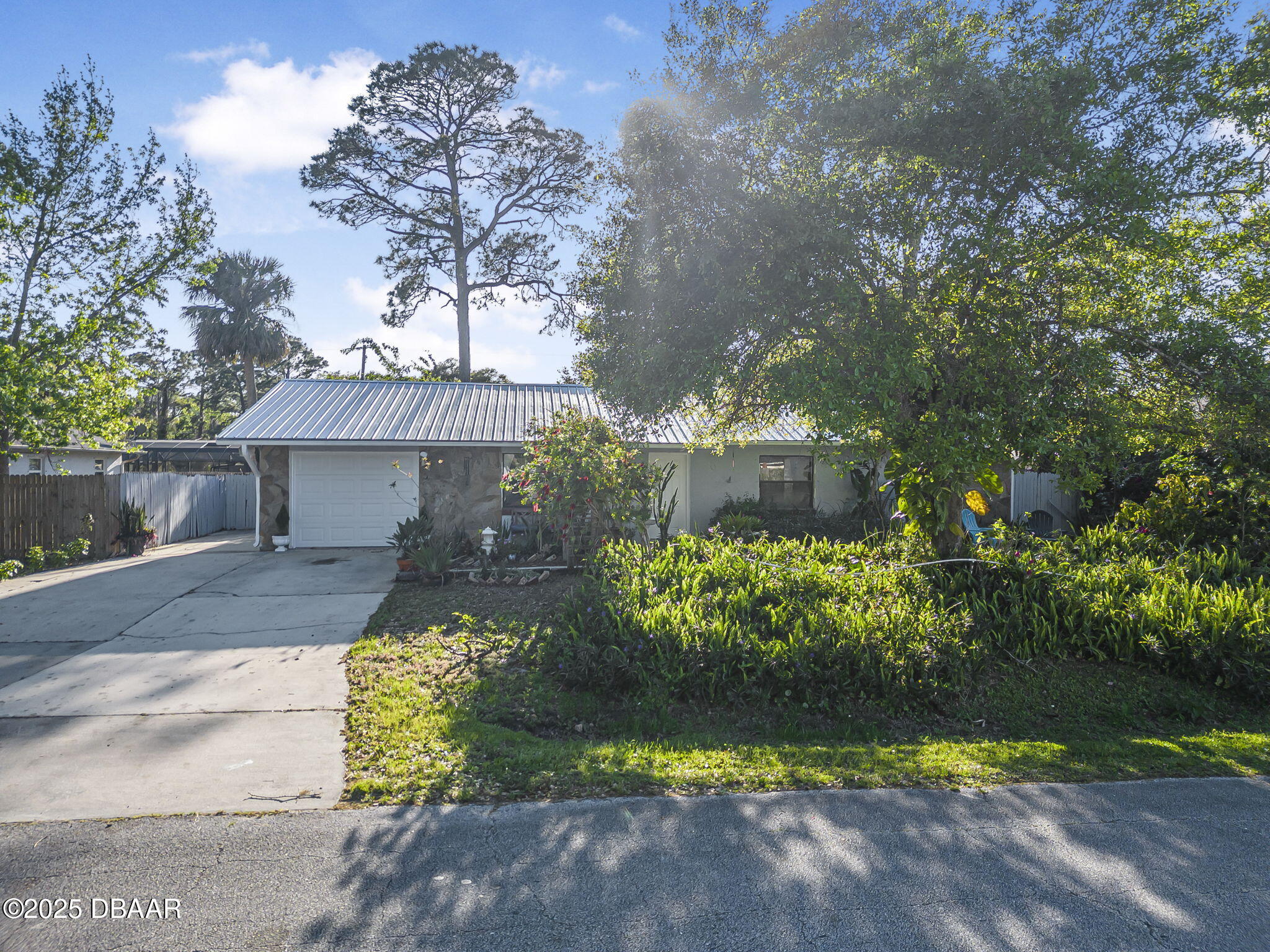 3228 Unity Tree Drive Edgewater, FL 32141 - Photo 2 of 37 a front view of a house with a yard and a garden
