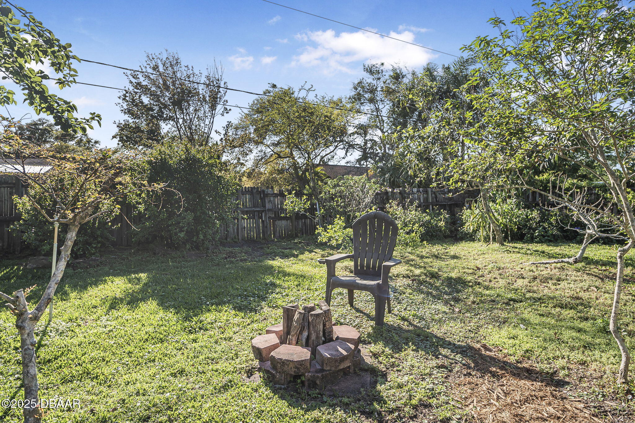3228 Unity Tree Drive Edgewater, FL 32141 - Photo 28 of 37 a view of a lake with a bench and trees around