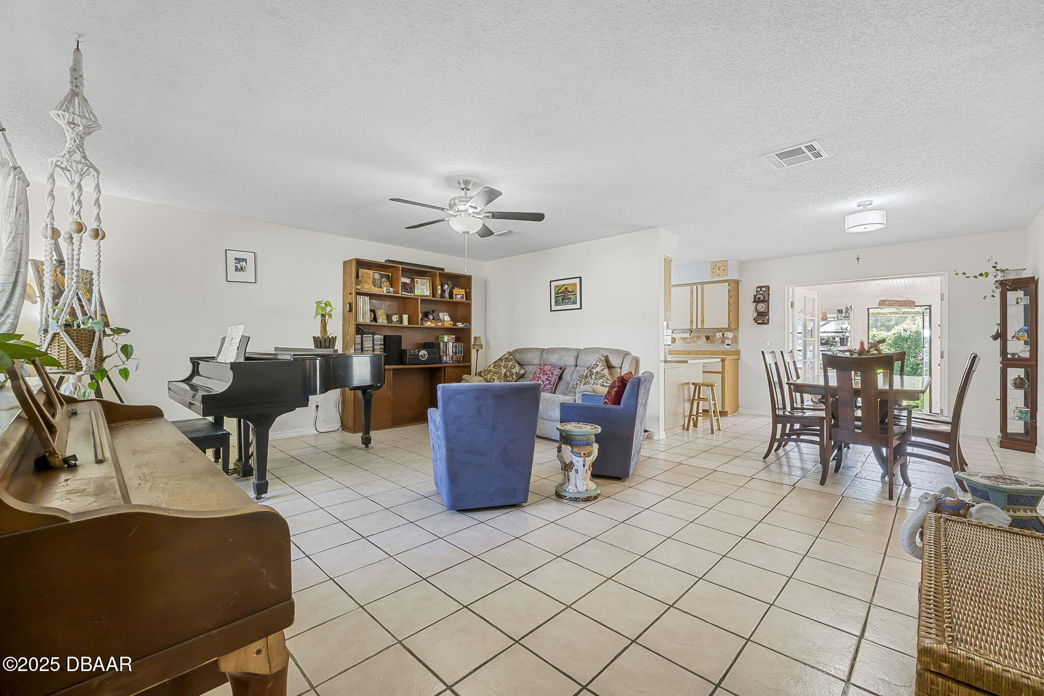 3228 Unity Tree Drive Edgewater, FL 32141 - Photo 5 of 37 a living room with furniture a dining table and a potted plant