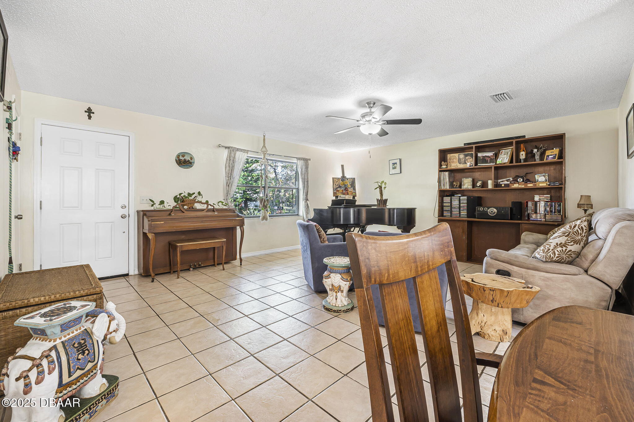 3228 Unity Tree Drive Edgewater, FL 32141 - Photo 6 of 37 a living room with furniture a table and chairs