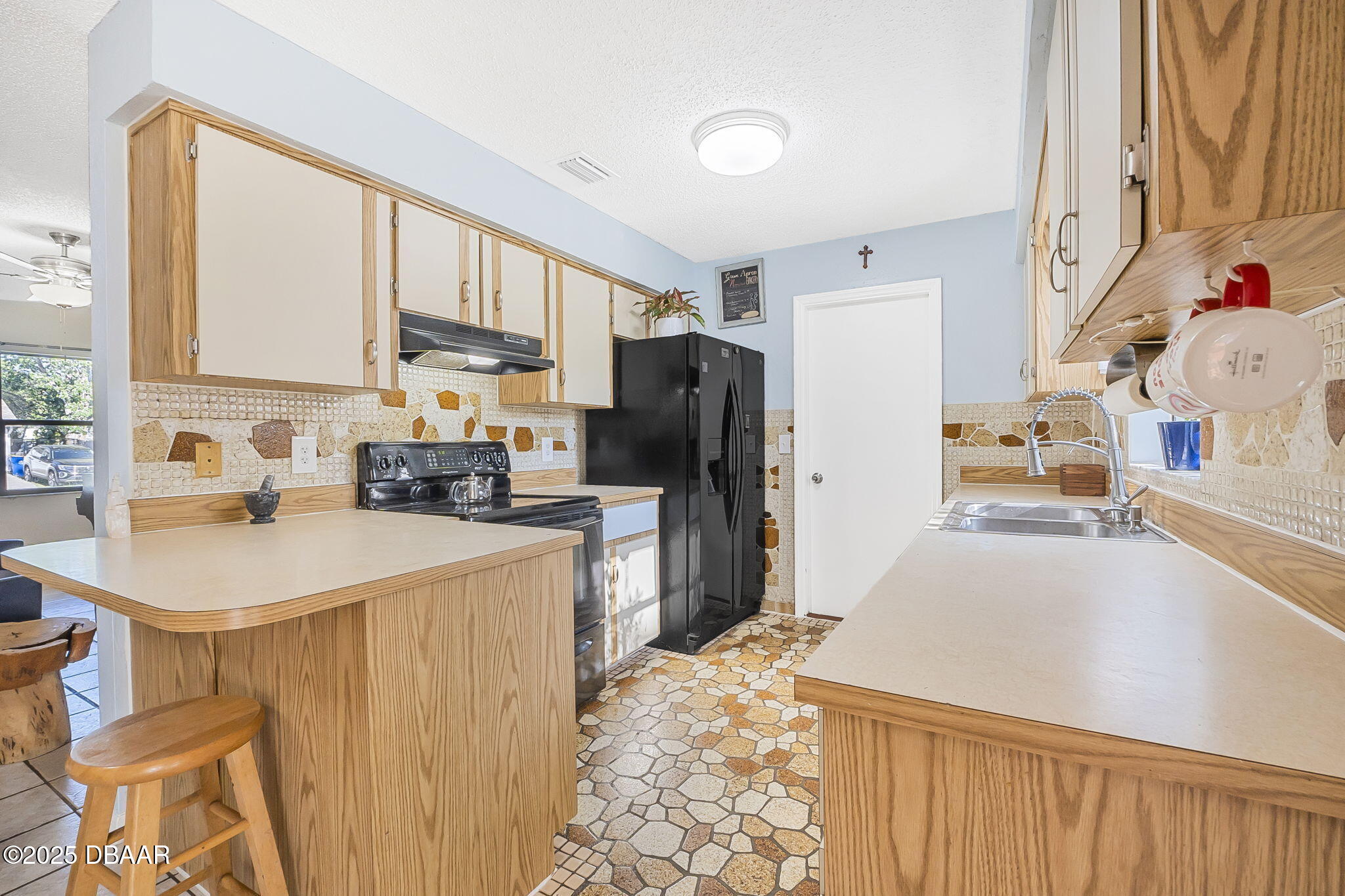 3228 Unity Tree Drive Edgewater, FL 32141 - Photo 9 of 37 a kitchen with a sink stove and refrigerator