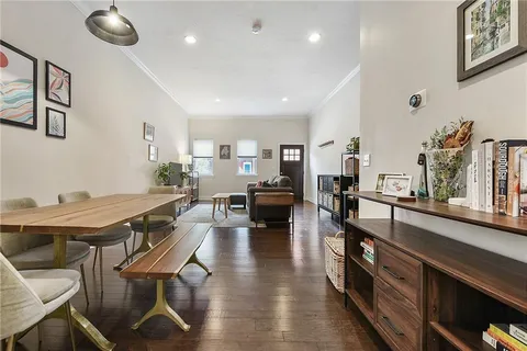 a living room with lots of furniture and a wooden floor