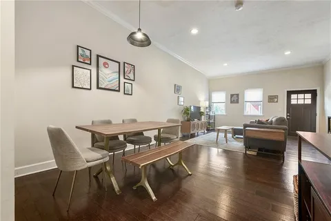 a living room with furniture and wooden floor