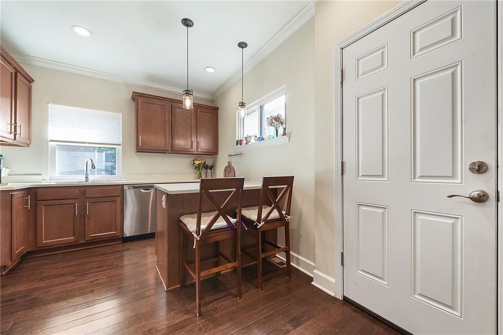 113 42nd Street Pittsburgh, PA 15201 - Photo 16 of 39 a kitchen with stainless steel appliances granite countertop a refrigerator a sink dishwasher a stove and white cabinets with wooden floor