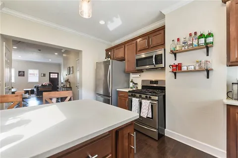 a kitchen with stainless steel appliances a stove microwave and a refrigerator