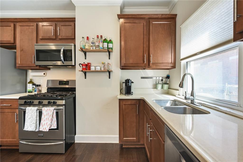 113 42nd Street Pittsburgh, PA 15201 - Photo 19 of 39 a kitchen with stainless steel appliances granite countertop a sink stove and microwave