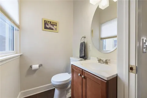 a bathroom with a toilet sink and mirror