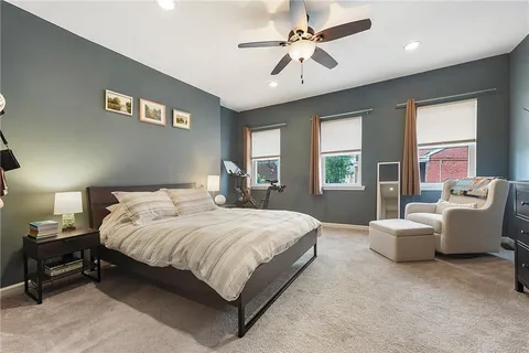 a spacious bedroom with a bed and a couch