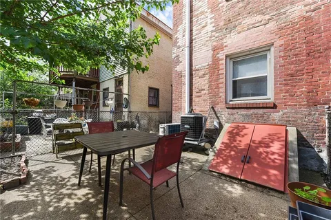 a backyard of a house with table and chairs