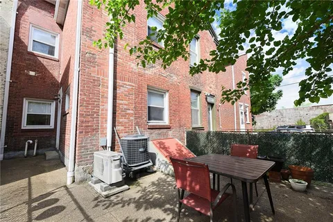 a backyard of a house with outdoor seating