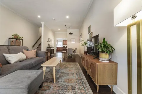 a living room with furniture and a potted plant