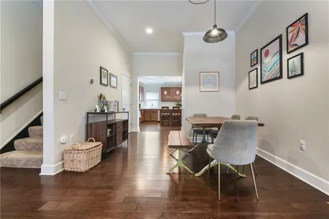 a view of a dining room with furniture wooden floor and a chandelier
