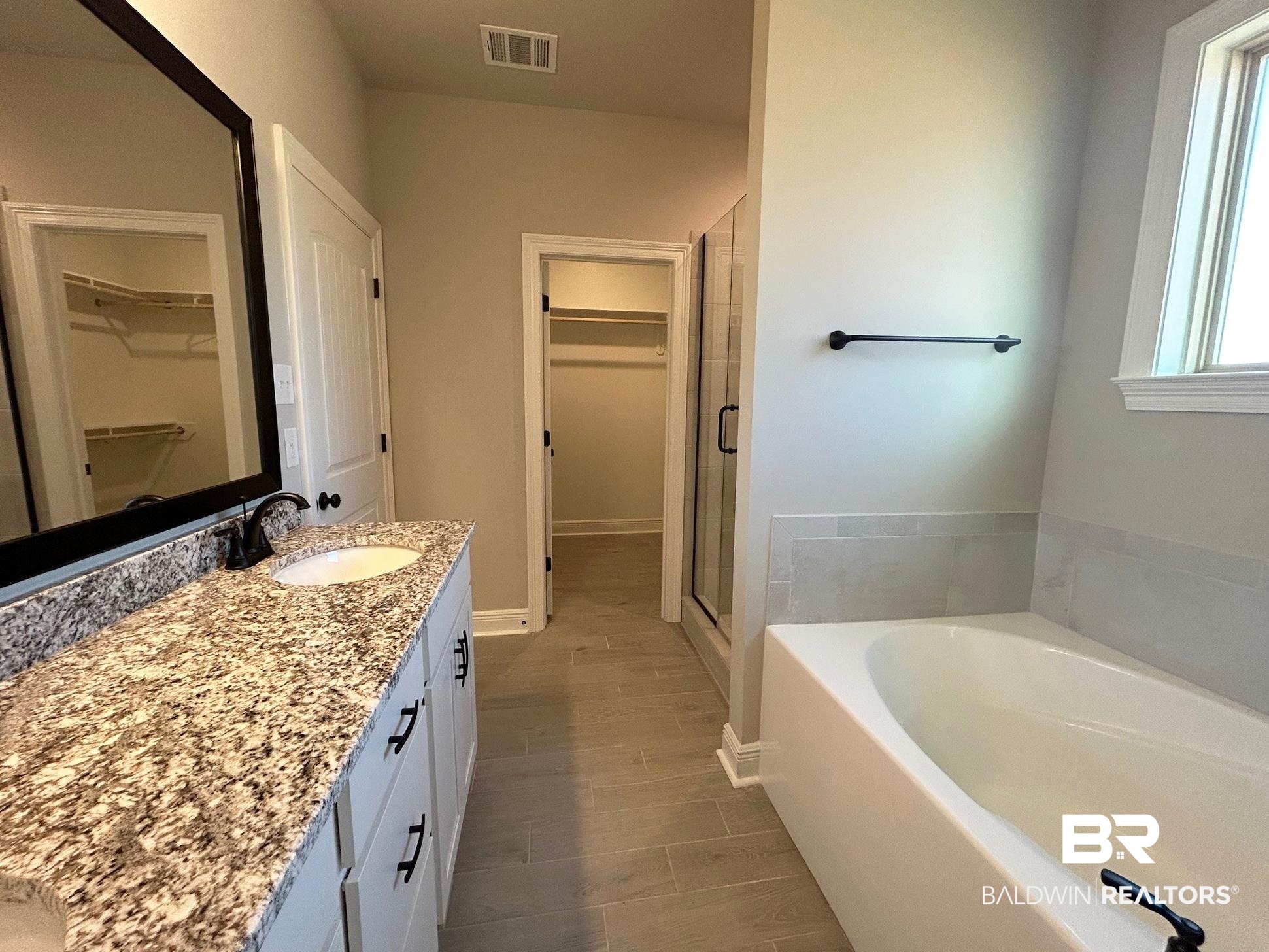 881 Sumter Loop Foley, AL 36535 - Photo 9 of 19 Bathroom with vanity and shower with separate bathtub