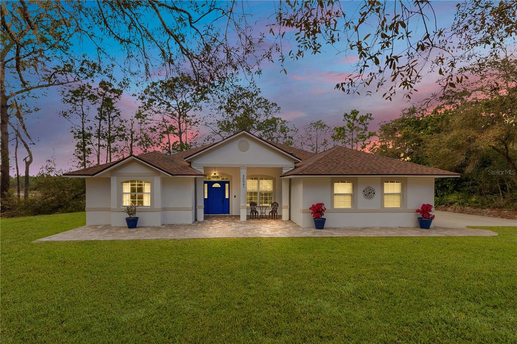 30041 Redoak Avenue Eustis, FL 32736 - Photo 1 of 1 a front view of a house with a yard and trees