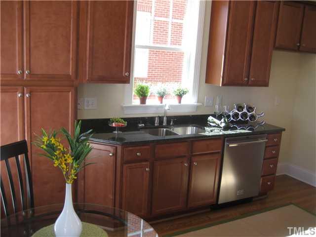 1532 Yarborough Park Drive Raleigh, NC 27604 - Photo 3 of 10 a kitchen with stainless steel appliances granite countertop a potted plant on the counter and cabinets