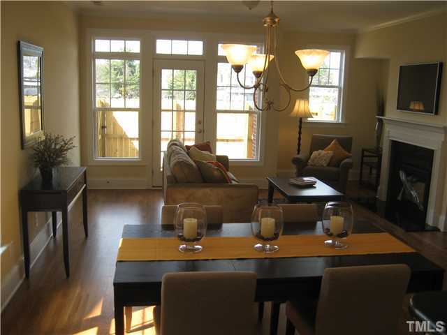 1532 Yarborough Park Drive Raleigh, NC 27604 - Photo 7 of 10 a dining room with a table chairs and a chandelier