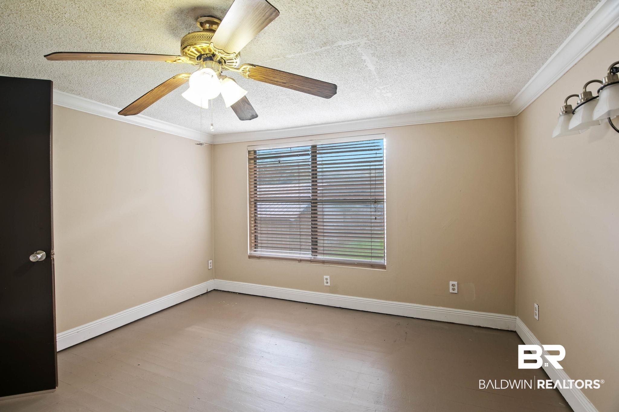 23240 County Road 47 Perdido, AL 36562 - Photo 14 of 29 Spare room with a textured ceiling, wood finished floors, crown molding, and a ceiling fan