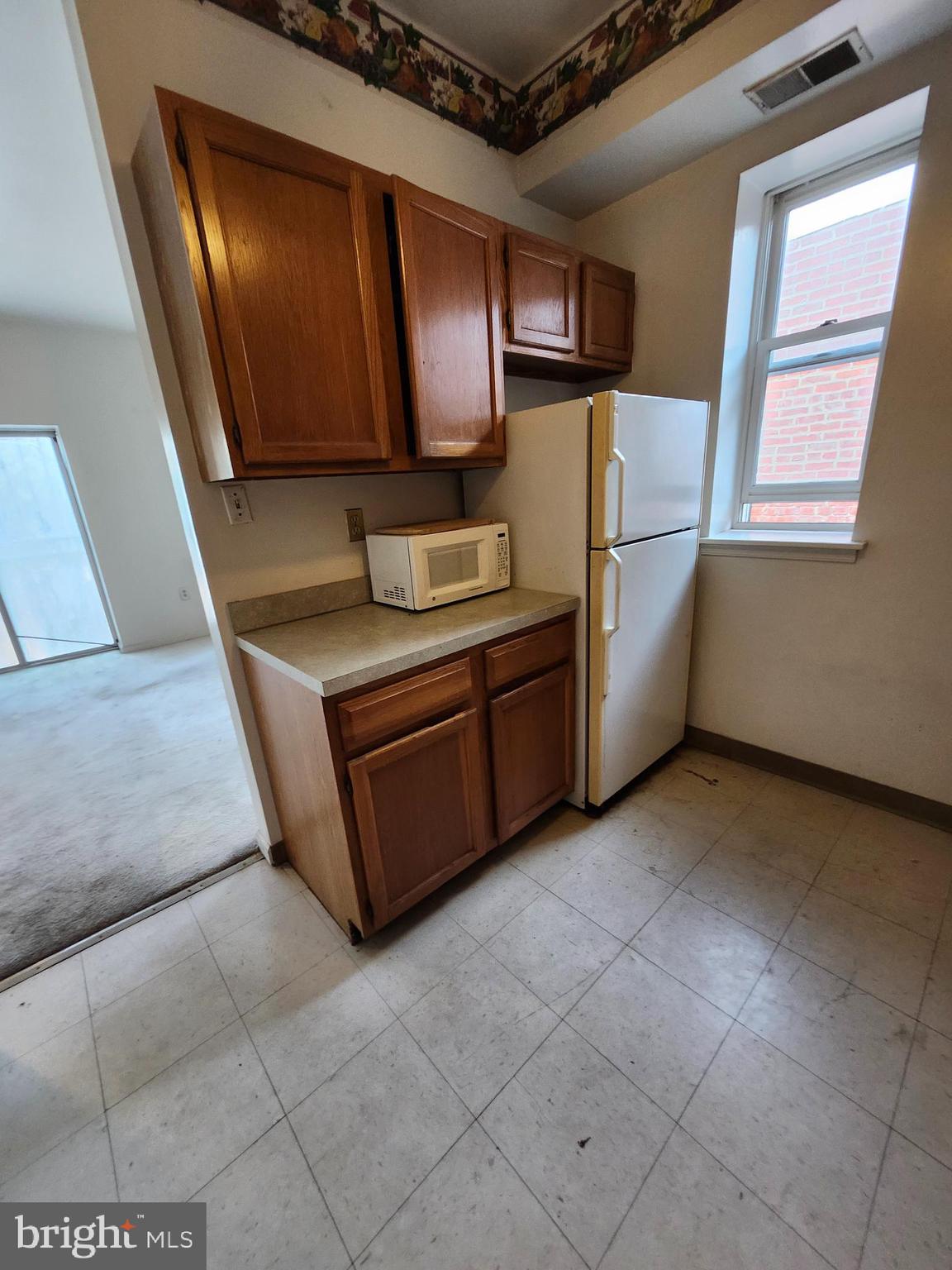 512 U Street Northwest, Unit 8 Washington, DC 20001 - Photo 5 of 9 a kitchen with stainless steel appliances granite countertop a stove a microwave and a refrigerator