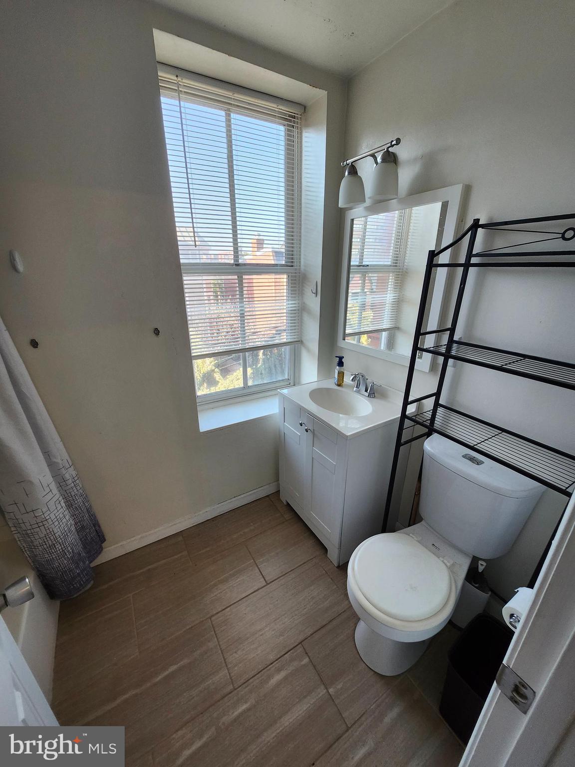 512 U Street Northwest, Unit 8 Washington, DC 20001 - Photo 8 of 9 a white toilet sitting next to a bathroom sink