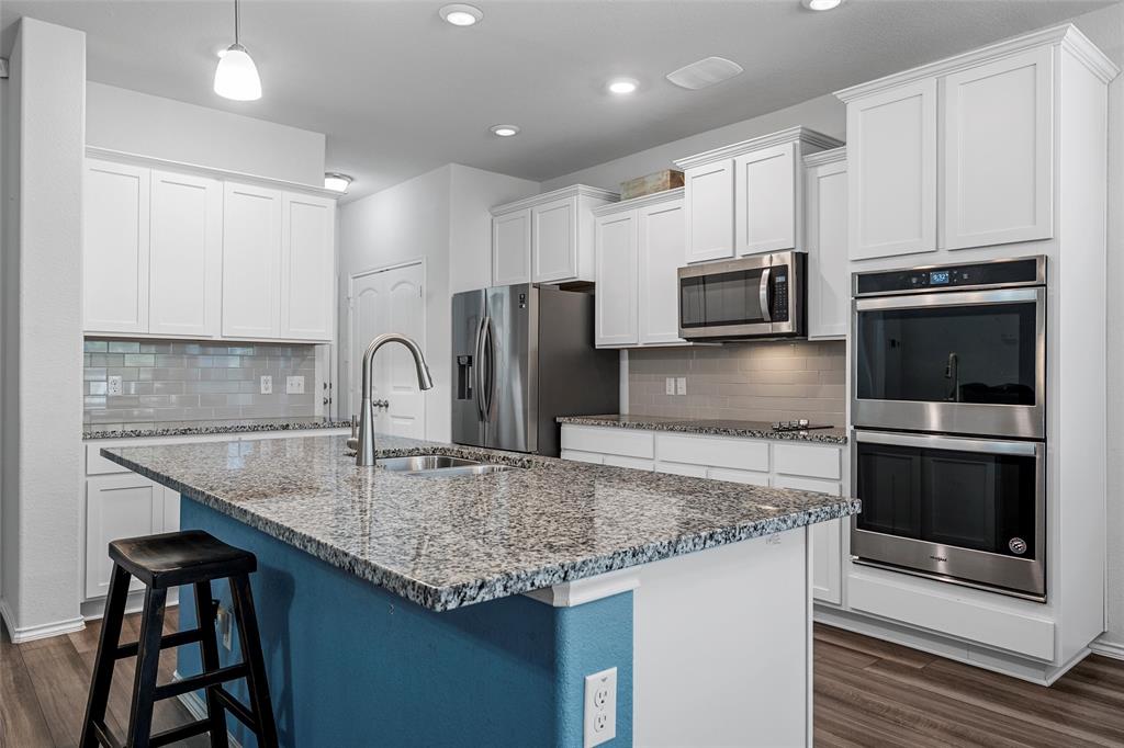 6201 Elephant Butte Drive Waco, TX 76708 - Photo 13 of 40 a kitchen with stainless steel appliances granite countertop a sink stove and refrigerator