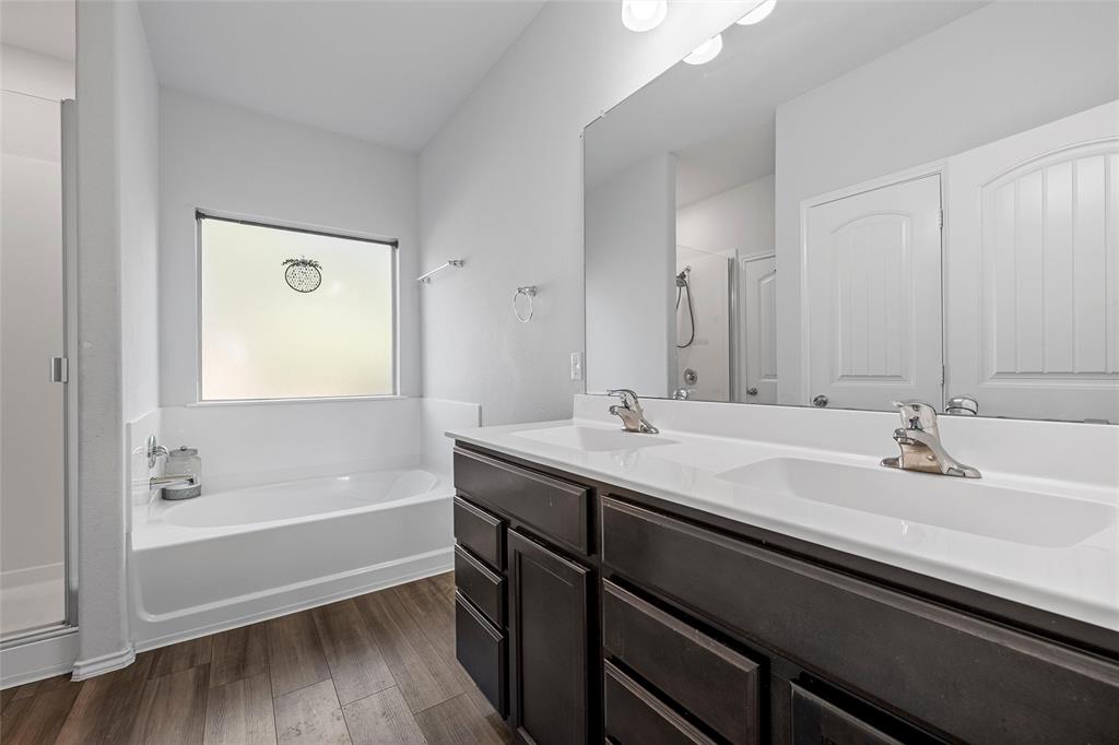 6201 Elephant Butte Drive Waco, TX 76708 - Photo 17 of 40 a bathroom with a tub sink and mirror