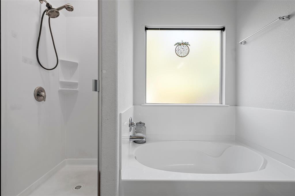 6201 Elephant Butte Drive Waco, TX 76708 - Photo 18 of 40 a bathroom with a bath tub with a shower