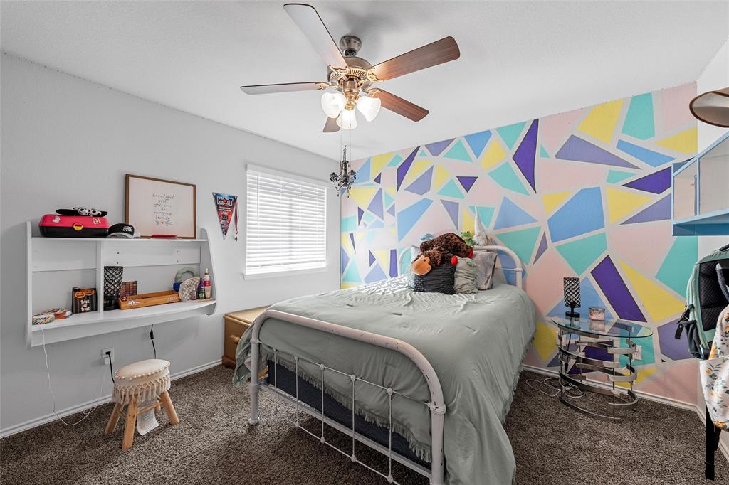 6201 Elephant Butte Drive Waco, TX 76708 - Photo 22 of 40 a bedroom with a bed and a chandelier