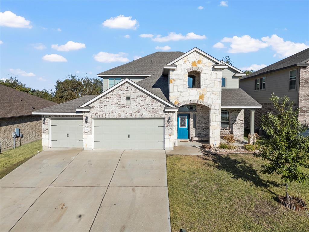 6201 Elephant Butte Drive Waco, TX 76708 - Photo 35 of 40 a front view of a house with a yard and garage