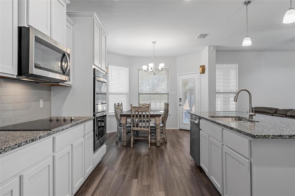 6201 Elephant Butte Drive Waco, TX 76708 - Photo 10 of 40 a kitchen with granite countertop a sink stove and cabinets