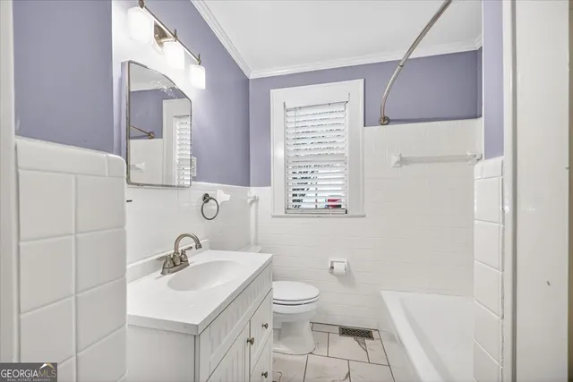 a bathroom with a sink toilet and a mirror