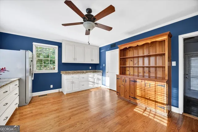 a view of empty room with a window and wooden floor