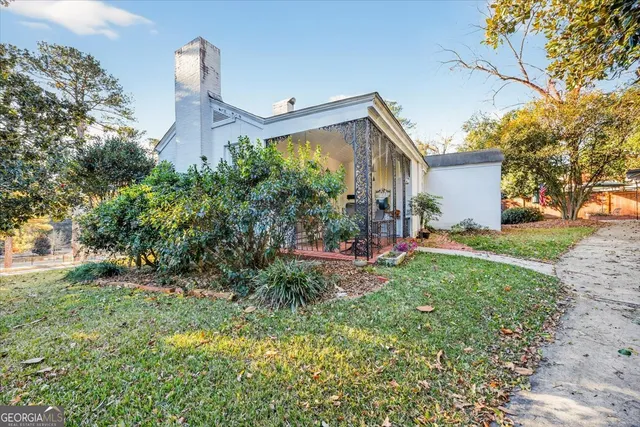 a front view of a house with a garden