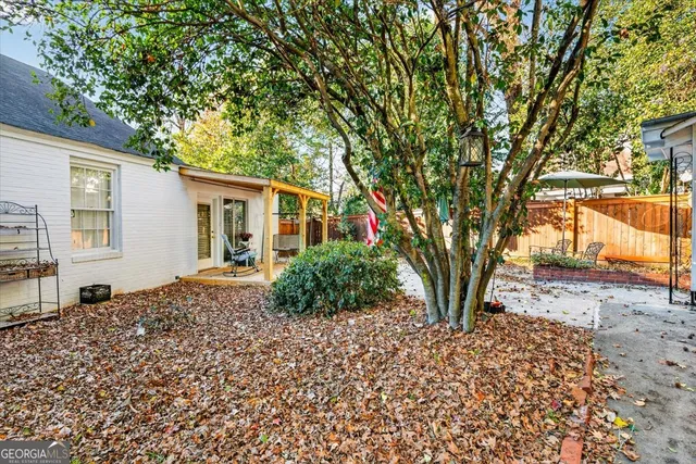 a backyard of a house with barbeque oven