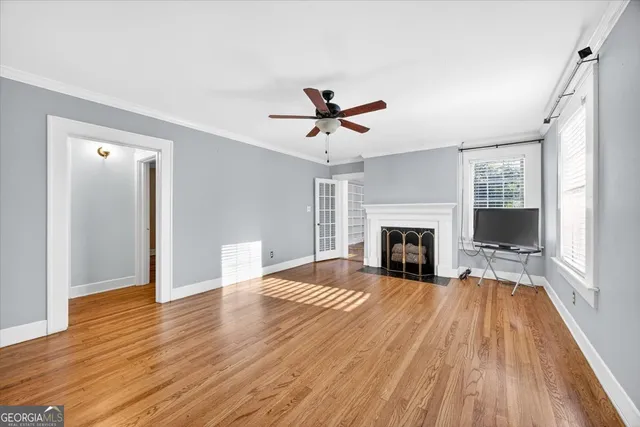 a view of a livingroom with a fireplace and wooden floor