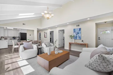 a living room with furniture and a chandelier