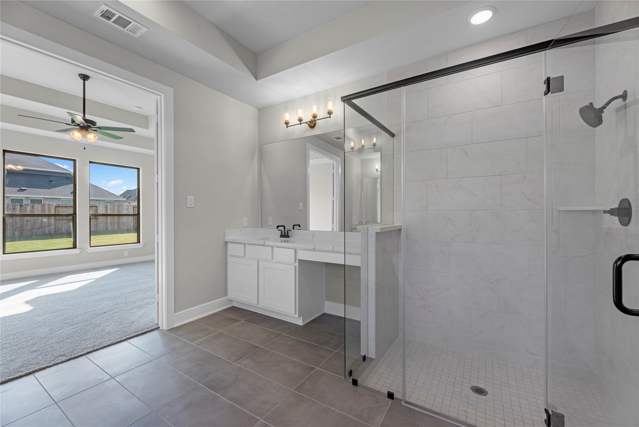 30927 Spring Lily Way Brookshire, TX 77423 - Photo 12 of 28 a bathroom with a double vanity sink a mirror and a shower