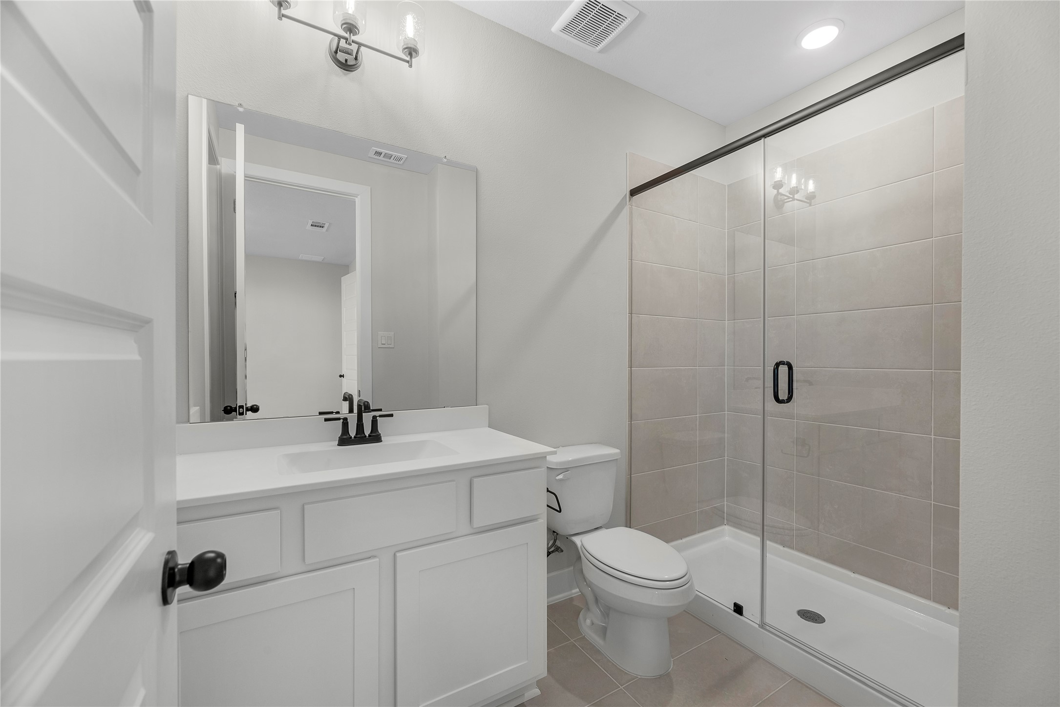 30927 Spring Lily Way Brookshire, TX 77423 - Photo 15 of 28 a bathroom with a shower sink vanity mirror and toilet