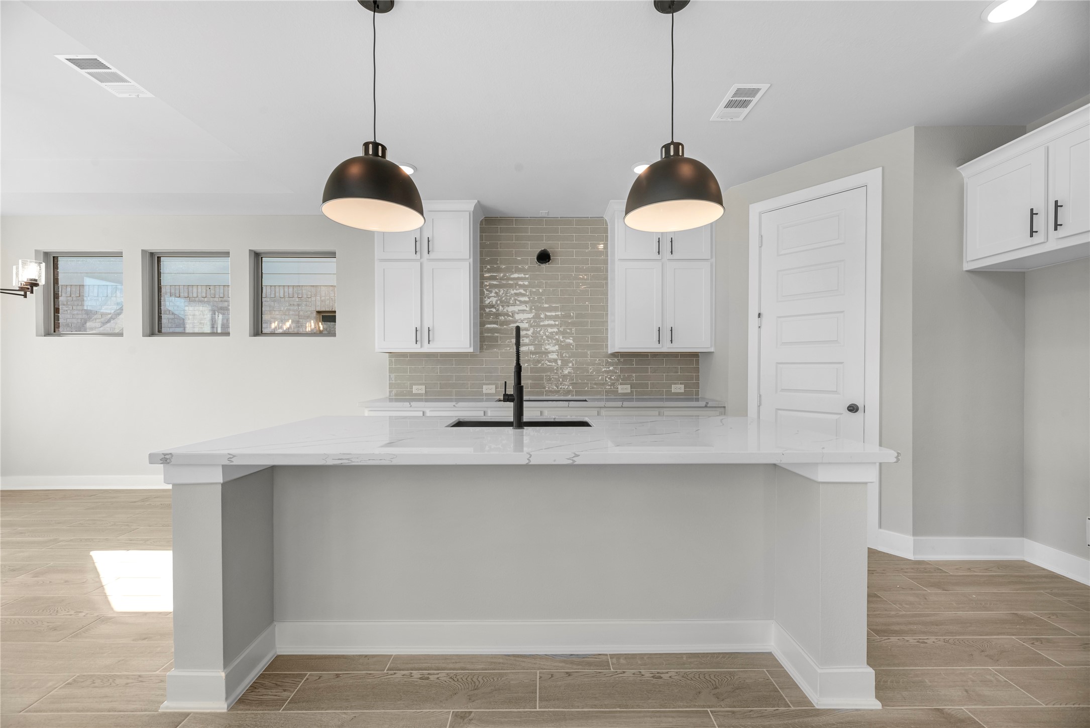 30927 Spring Lily Way Brookshire, TX 77423 - Photo 5 of 28 a kitchen with a sink and a chandelier