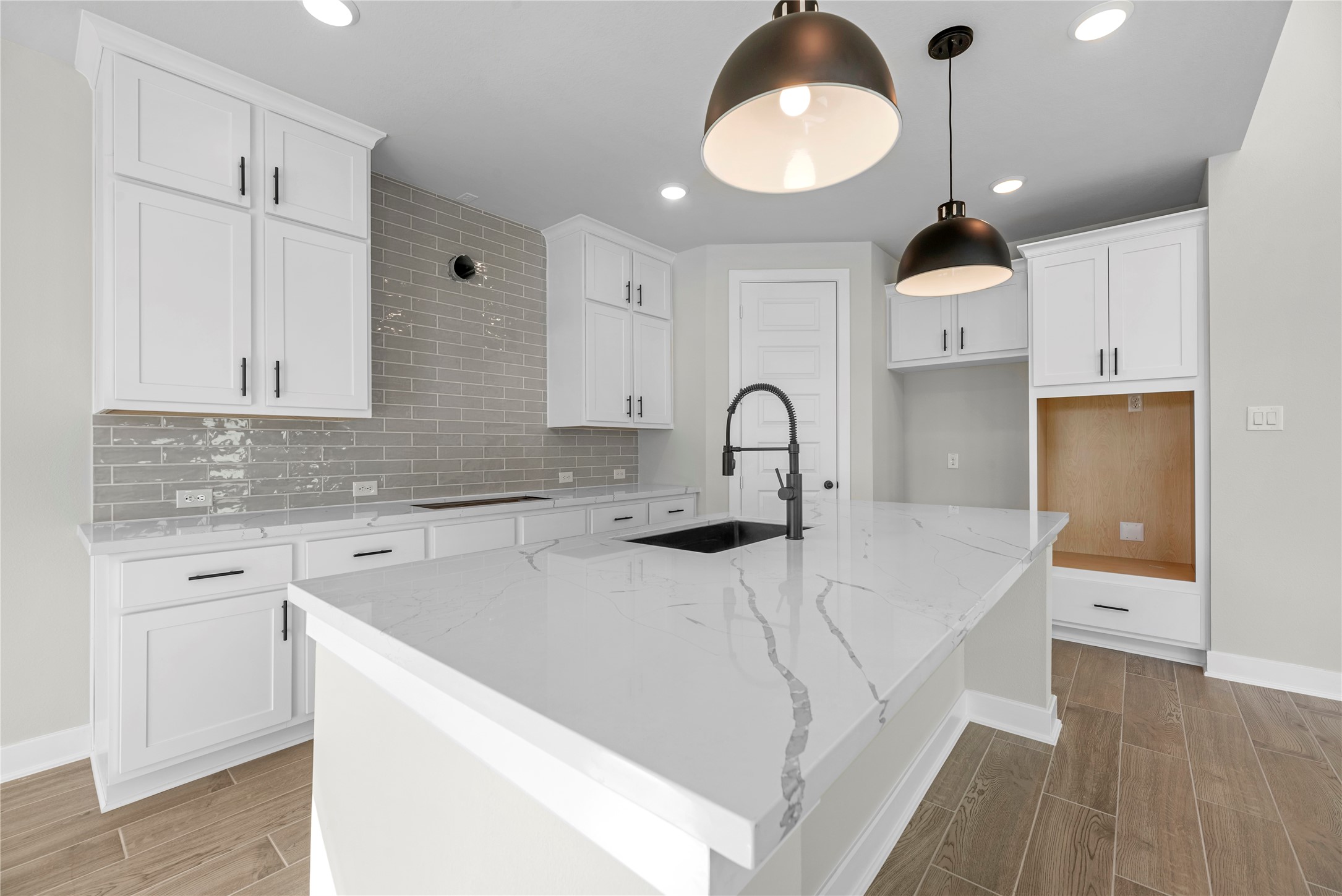 30927 Spring Lily Way Brookshire, TX 77423 - Photo 6 of 28 a kitchen with kitchen island a sink stainless steel appliances and cabinets