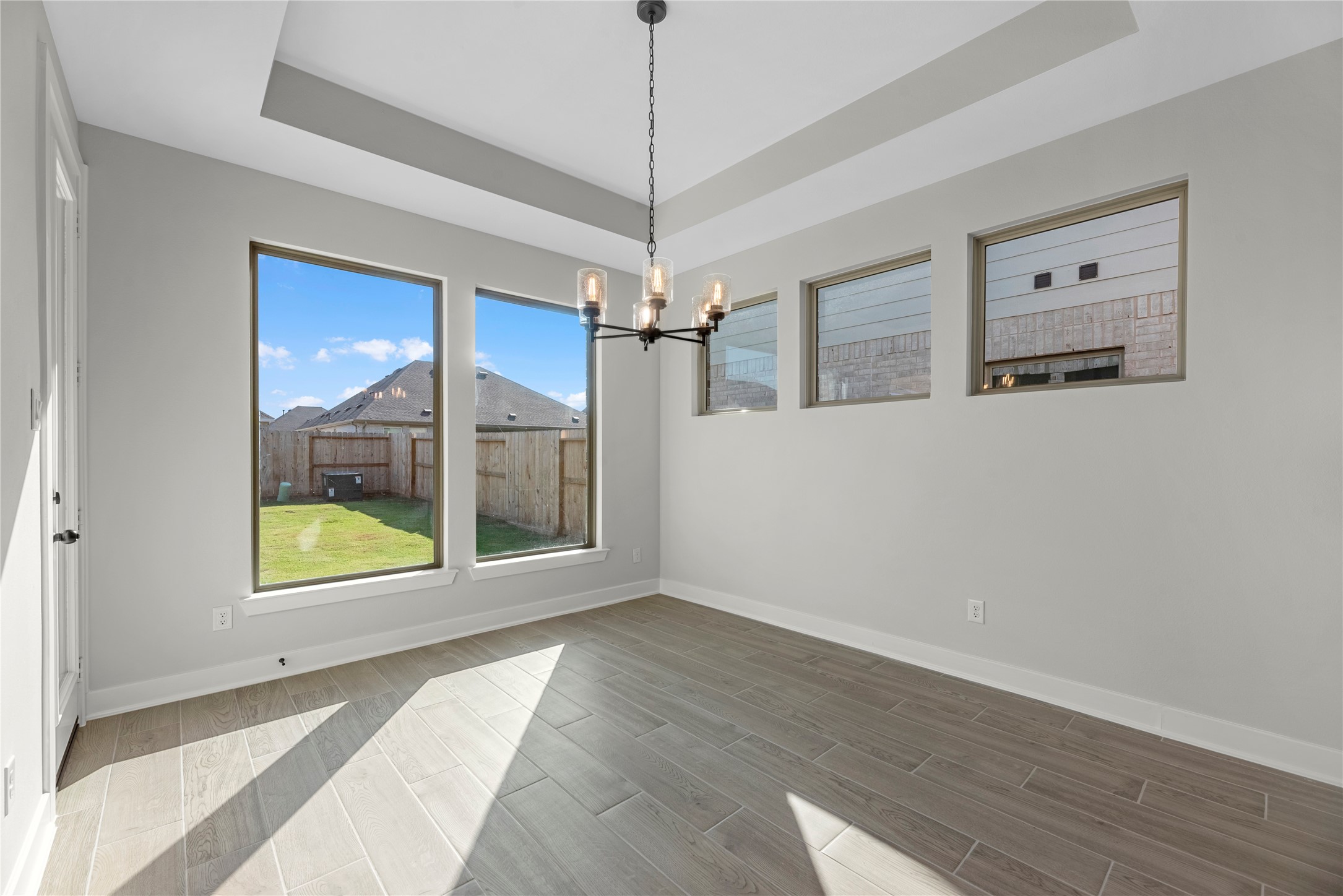 30927 Spring Lily Way Brookshire, TX 77423 - Photo 9 of 28 a view of a hallway with wooden floor and a chandelier
