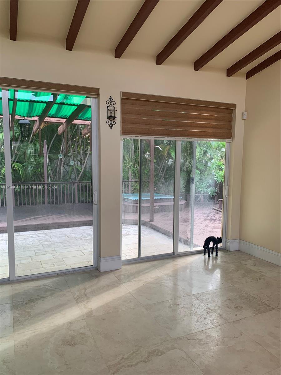 310 191st Terrace Sunny Isles Beach, FL 33160 - Photo 13 of 36 a view of a room with a large window and wooden floor