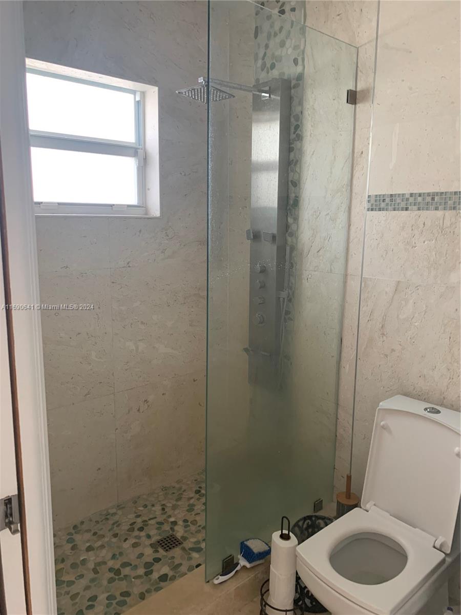 310 191st Terrace Sunny Isles Beach, FL 33160 - Photo 20 of 36 a bathroom with a toilet and a shower