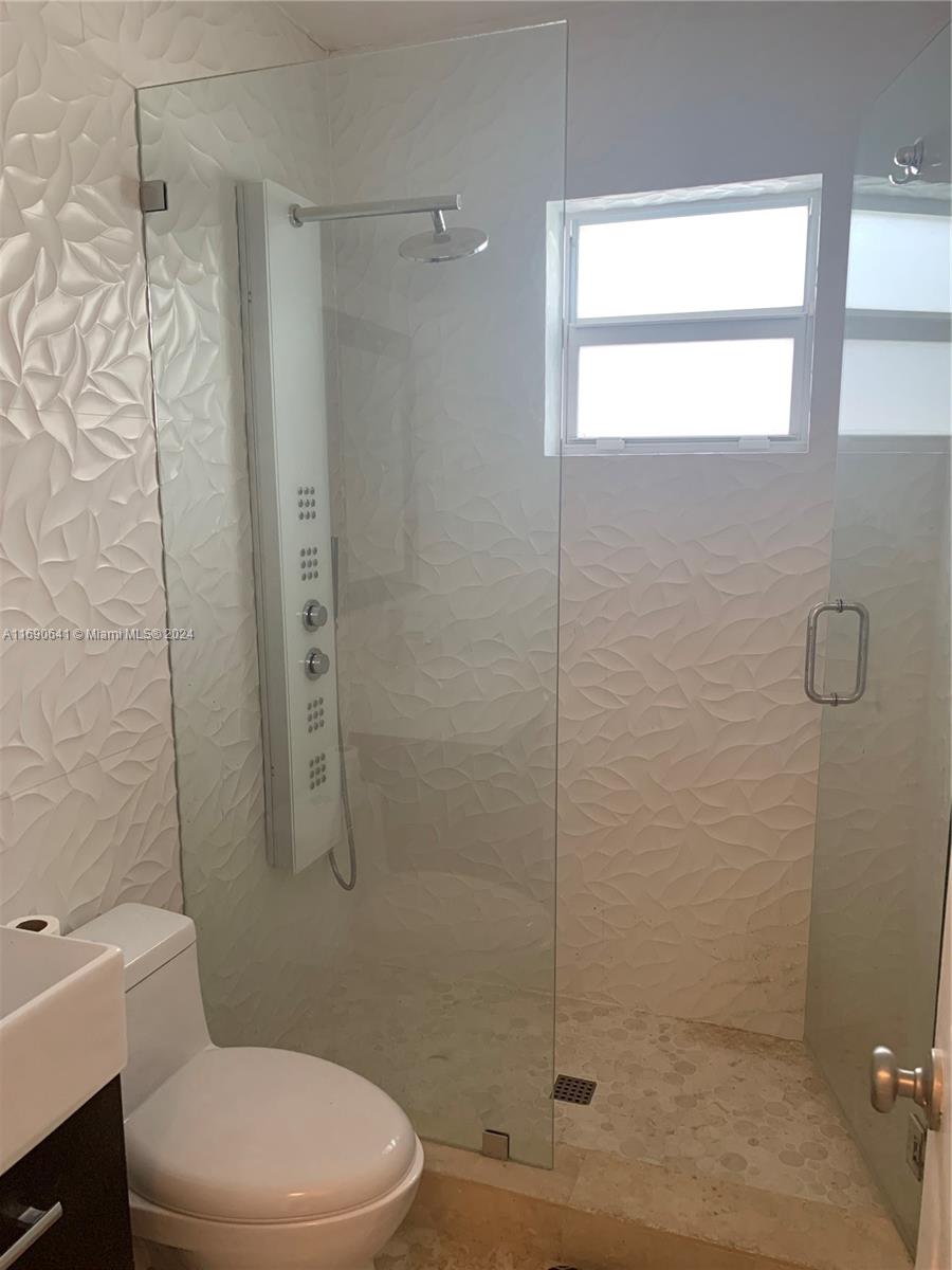 310 191st Terrace Sunny Isles Beach, FL 33160 - Photo 21 of 36 a bathroom with a toilet and shower