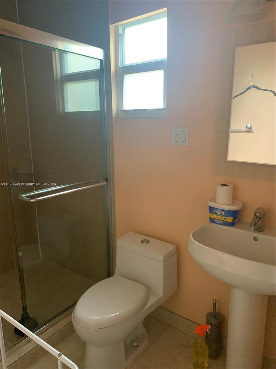 310 191st Terrace Sunny Isles Beach, FL 33160 - Photo 25 of 36 a white toilet sitting next to a bathroom sink